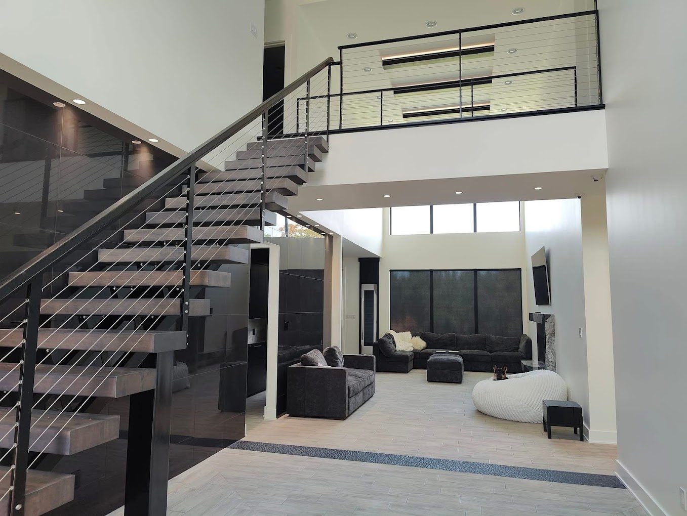 Modern living room with custom roller shades by Precision Shades